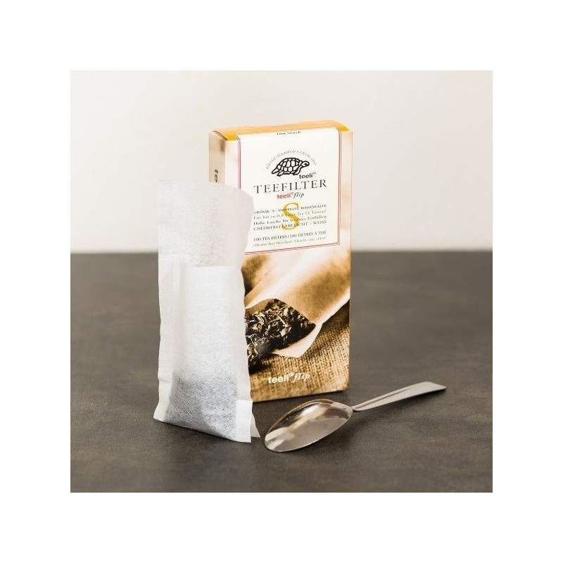 Sachet de thé vide Thés et Traditions avec boîte et cuillère sur table sombre