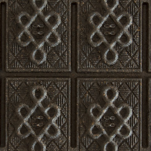 Pu-Erh-Teeziegel mit geometrischen Reliefmustern auf dunkler Oberfläche