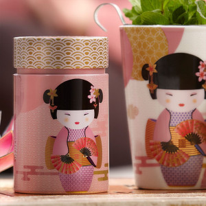 Little Geisha pink tea box with illustration of geisha holding a fan and golden Japanese patterns