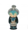 Ceramic infuser character with leopard print hat and blue and black dragon pattern dress