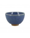 Dark blue celadon cup with crackled texture and terracotta base