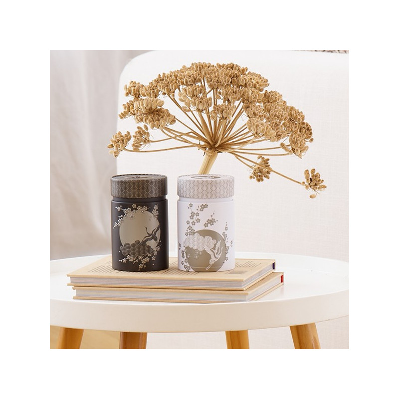 Komorebi 150g tin decorated with Japanese motifs placed on books with dried plant in background