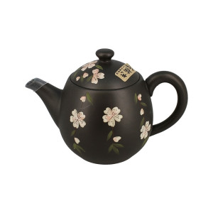 Schwarze Tokoname-Teekanne mit weißen Blütenmotiven und grünen Blättern aus traditioneller Keramik