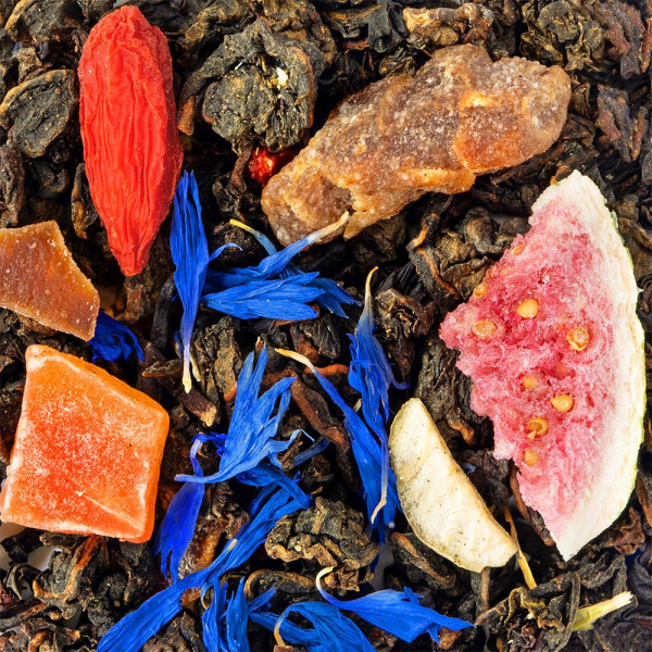 Blend of oolong tea with goji berries cornflower blossoms dried fruit pieces and sugar crystals