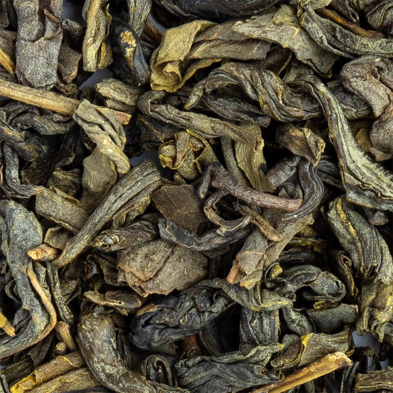 dried Chun Mee green tea leaves rolled and twisted with green and brown nuances