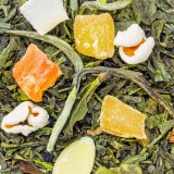 Groene thee Nuage d'Amandes met stukjes amandel en gedroogd fruit op groene theebladeren