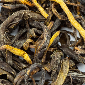 Whole dried yellow tea leaves with yellow and brown hues for delicate infusion