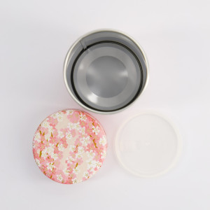 Scatola rotonda in metallo con coperchio decorato con fiori di ciliegio rosa e bianchi motivo washi