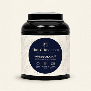 Runde schwarze Teedose mit Oolong Mandel Schokolade von Thés & Traditions, cremefarbenes Etikett mit Blattmuster und dunkelblaue