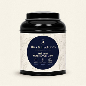 Schwarze runde Teedose von Grüntee Minze von Thés & Traditions, cremefarbenes Etikett mit Blattmuster und dunkelblauem Medaillon