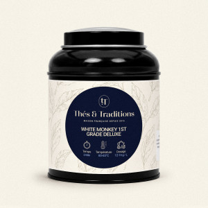 Schwarze runde Teedose von Grüntee White Monkey 1st Grade Deluxe Thés & Traditions mit cremefarbener Banderole und Blattmotiv