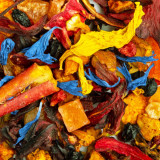 Hibiscaïa herbal tea blend with blue and yellow flowers, red fruit pieces and colorful spices