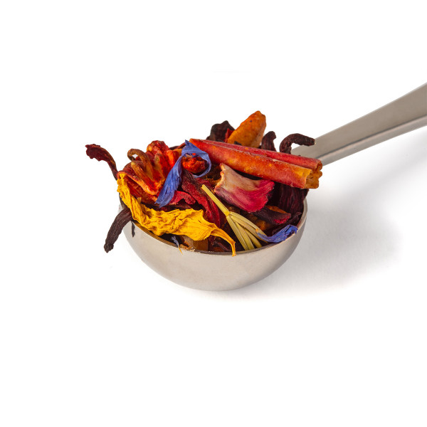metal tea spoon filled with dried flowers and colorful spices for infusion
