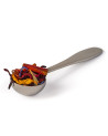 Stainless steel tea spoon filled with dried flowers and spices for infusion