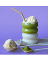 Bevanda matcha vaniglia con ghiaccio, polvere di matcha e gelato alla vaniglia su sfondo viola