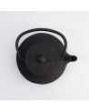 Black cast iron teapot with curved handle and arare style textured surface