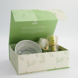 Matcha tea set with bowl bamboo whisk spoon and pale green leaf-patterned holder