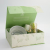 Matcha tea set with bowl bamboo whisk spoon and pale green leaf-patterned holder