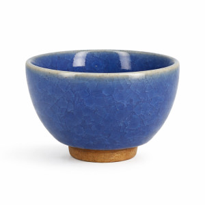 Dark blue celadon cup with crackled texture and terracotta base