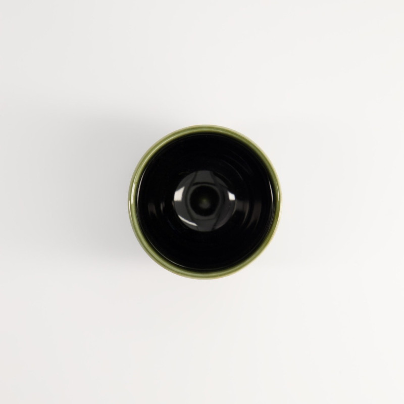 Yunomi Oribe cup black interior and light green rim on white background