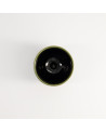 Yunomi Oribe cup black interior and light green rim on white background