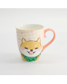 Ceramic mug with smiling Shiba dog illustration, pink grid background, and pink handle