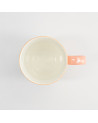 Peach-colored Shiba mug with white interior and handle decorated with white motifs