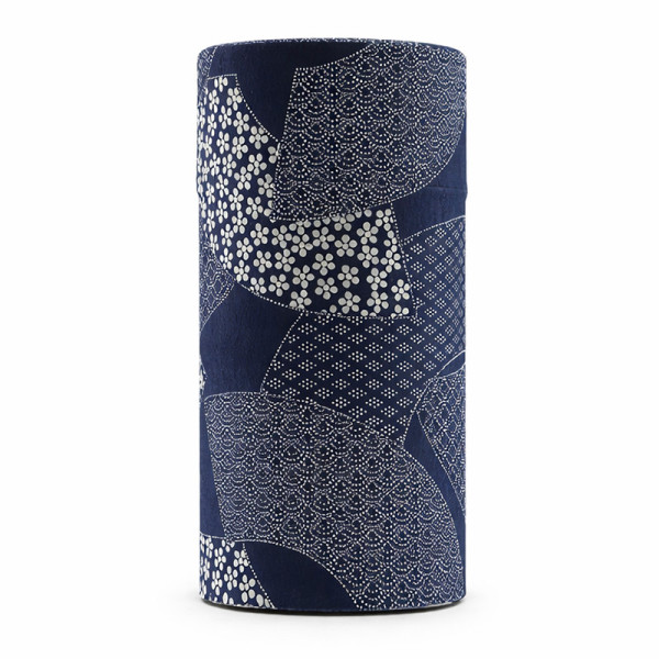 Cylindrical washi paper box with white Japanese patterns on a navy blue background