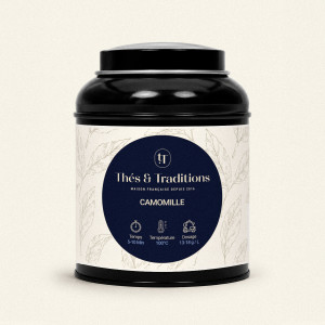 Lattina rotonda nera di Camomilla Thés & Traditions, etichetta crema con motivo di foglie e medaglione blu navy e oro